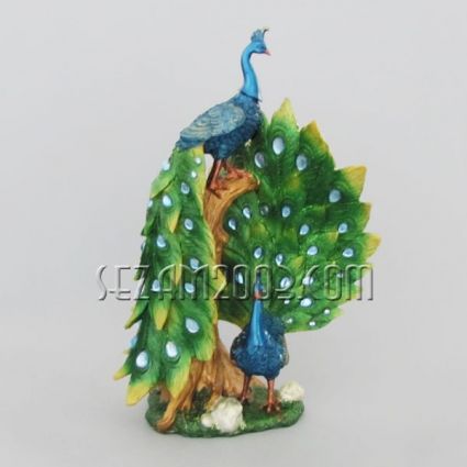 Resin peacock decorated with pebbles
