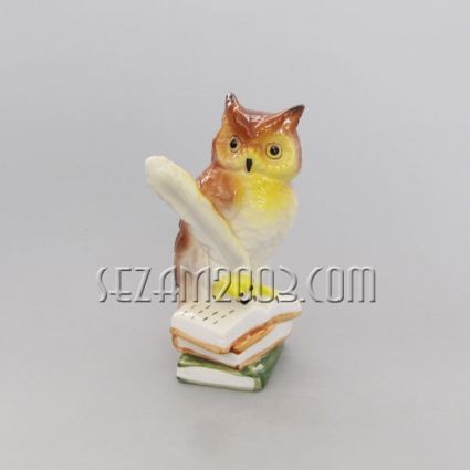 Owl with a quill and books – figurine made of colored porcelain and gold.